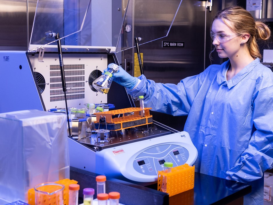 tx-asm-front Microbiology student researcher working with cultures at an incubator.